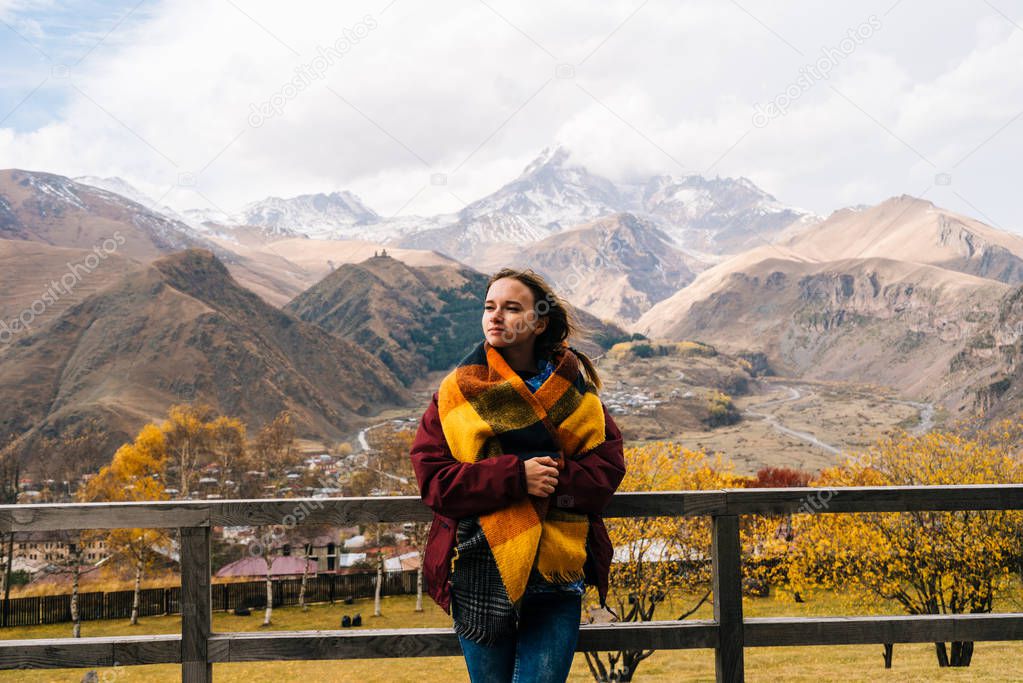 A young girl traveler enjoys the clean mountain air and the scenery