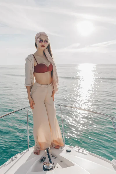 A fényűző fiatal nő elegáns nyári ruha pózol a neki yacht, élvezi a nyaralás és a nyári — Stock Fotó