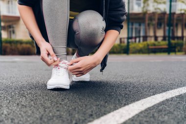 ince kız açık spor sahasında onu koşu ayakkabıları, ayakkabı bağcığı kravat