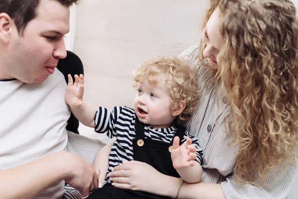 Friendly young family, parents, mom and dad playing with their little fair-haired son — Stock Photo, Image