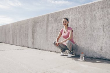 sportif kız açık havada güneşin altında oturan bir aktif ve sağlıklı yaşam tarzı önde gelen gülümseyen