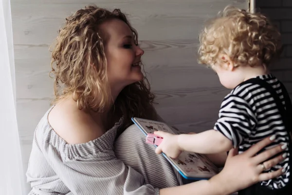 Cute curly woman playing with her little baby boy, having fun and laughing — Stock Photo, Image