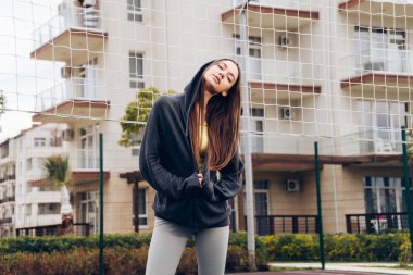 spor sahasında poz, egzersizleri yapıyor ve eğitim emin uzun saçlı kız