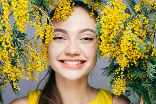 çekici kız sarı kokulu Mimoza ile poz kameraya bakarak gülen