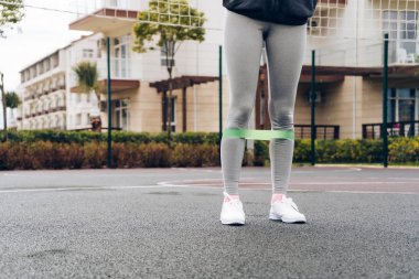 ince kız açık spor alanı üzerinde ayak kasları için egzersiz yapar, kilo vermek istiyor