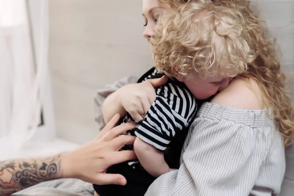 Happy family, curly young mother hugging her little son — Stock Photo, Image