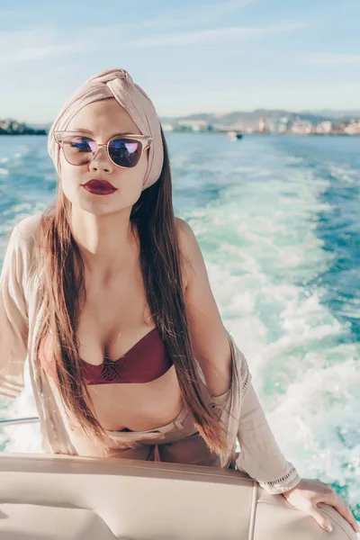 Una mujer hermosa rica en gafas de sol nada en el mar Caribe, disfruta del calor del verano —  Fotos de Stock