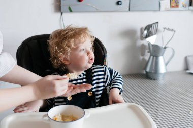 şefkatli anne beslemeleri onun küçük kıvırcık oğlu lezzetli mısır gevreği, Aile kahvaltı