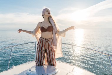 bir lüks şık kız trendy yaz giysileri bir yatta aittir, Karayip Denizi adaya yelken