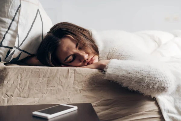 Fiatal lány fekszik az ágyban, aludt, nem hallja meg a ébresztőóra gyűrű — Stock Fotó