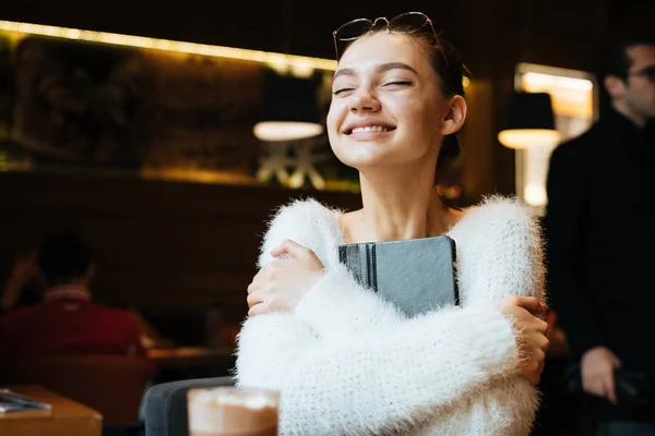 Happy young girl freelancer finished all work, keeps her notebook and rejoices — Stock Photo, Image