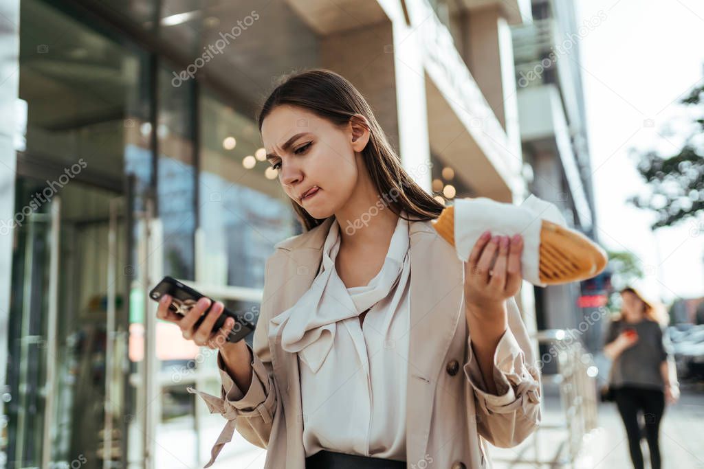 The busy businesswoman working online on a smartphone during a break