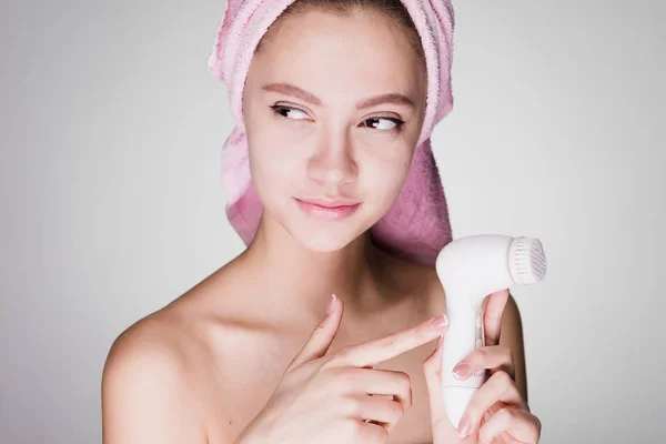 Woman on a white background holds a brush for deep cleaning — Stock Photo, Image