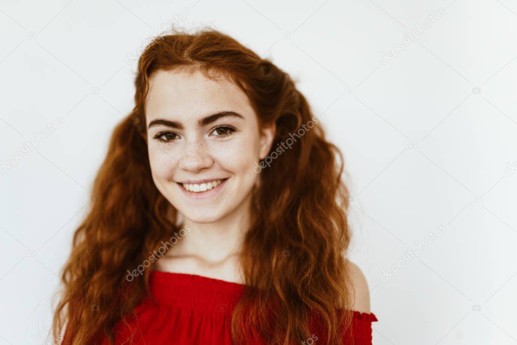 curious schoolgirl smiles on light gray background