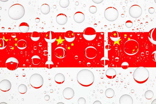 Flag of China behind a glass covered with raindrops.