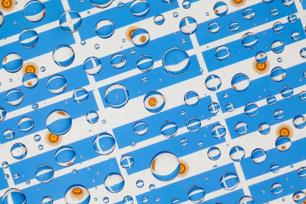 Flags  of Argentina, behind a glass covered with rain drops.Pattern from Argentine flags