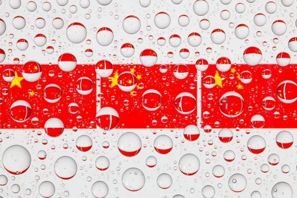 Flags  of China behind a glass covered with raindrops.
