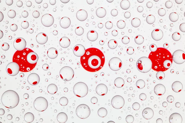 Flags  of Japan behind a glass covered with raindrops.