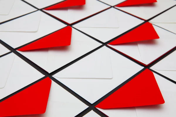 Composition with white and red envelopes on the table. The photo suitable for various holidays and anniversaries.