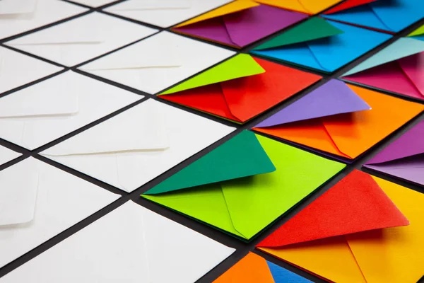 Composition with white and colored envelopes on the table. The photo suitable for various holidays and anniversaries.