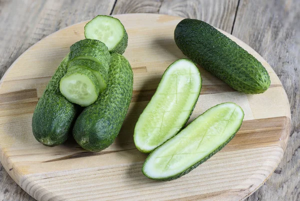 Fresh cucumbers, halves of cucumbers and slices of cucumber, rusric style