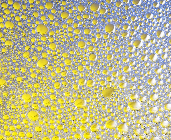 Buborékok a kék és a sárga háttér és textúra — Stock Fotó