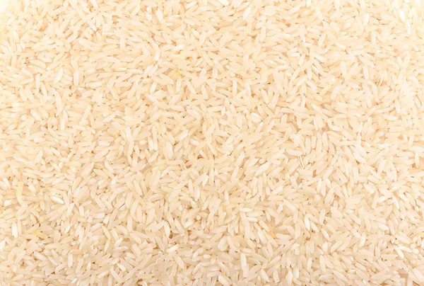 Riso a grani lunghi come sfondo. Tessitura di riso — Foto Stock