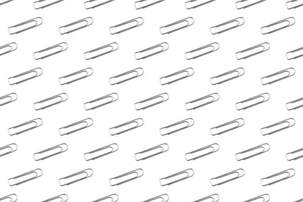 Pattern of stationery steel clips as a background or texture.