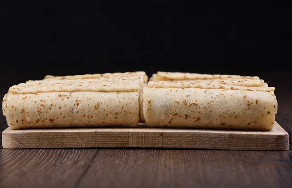 Pancake rolls on a wooden cutting board — Stock Photo, Image