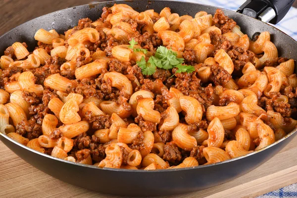 Pasta with ground beef and tomato paste in a pan. — Stock Photo, Image