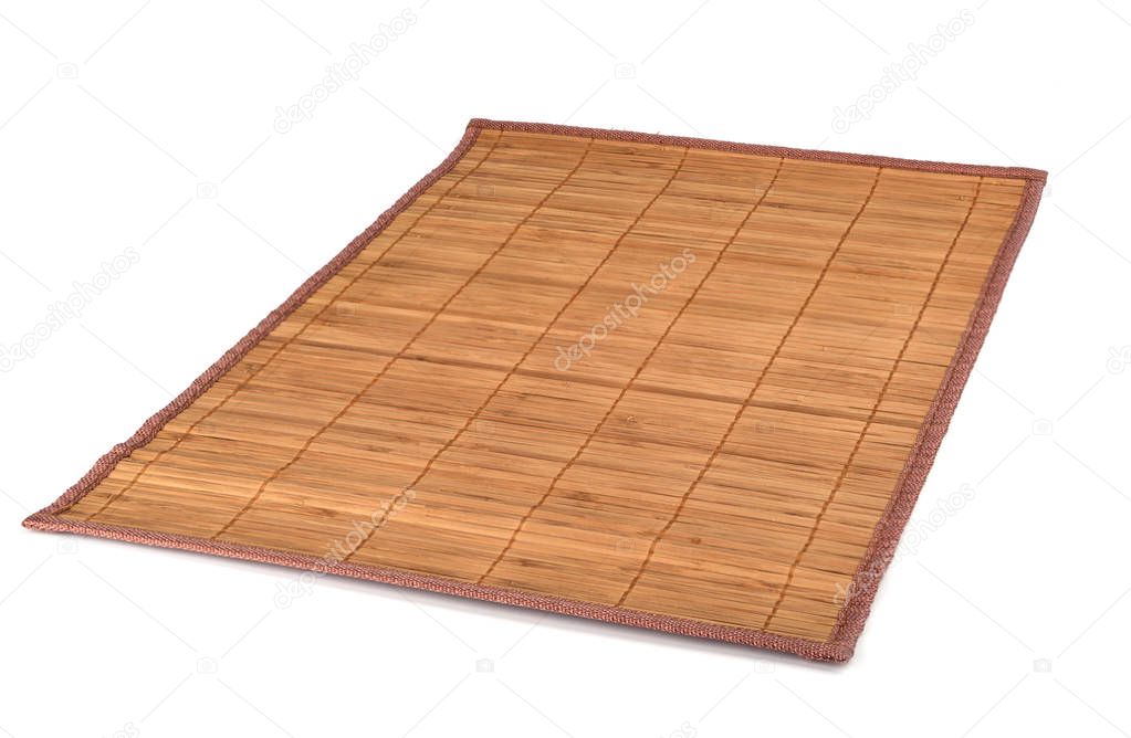 Bamboo sushi mat isolated on white background. Traditional Japanese or Chinese table setting.