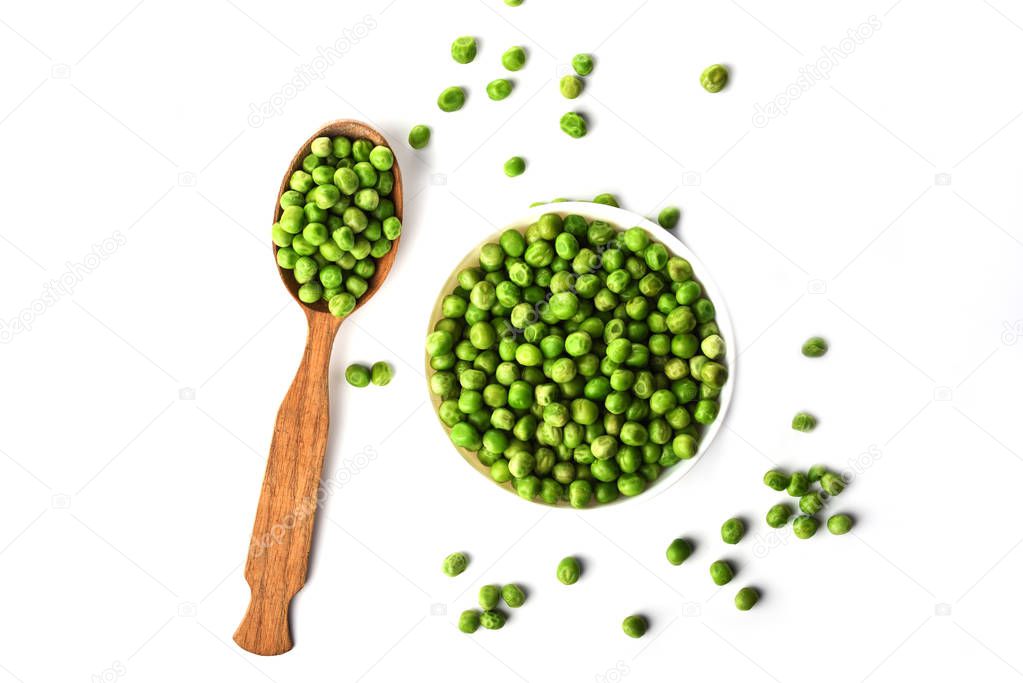 Top view. Green peas in white bowl and wooden spoon isolated on 