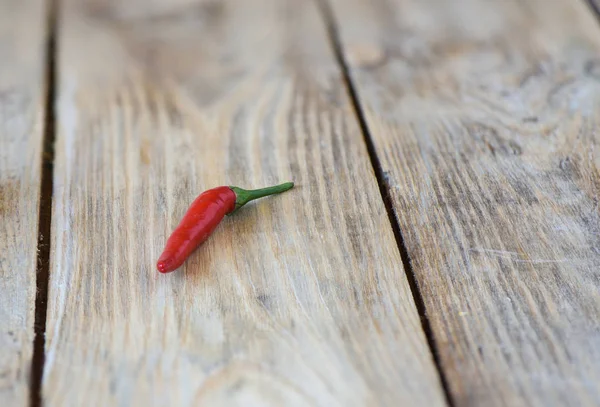 Pod of red hot pepper on wooden background. — Stock Photo, Image