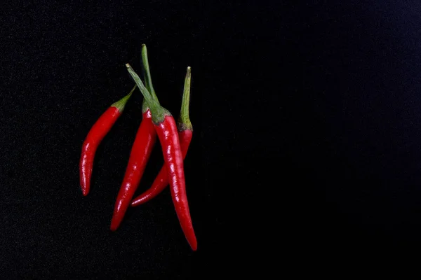 Pods of red hot pepper isolated on black color background. — Stock Photo, Image