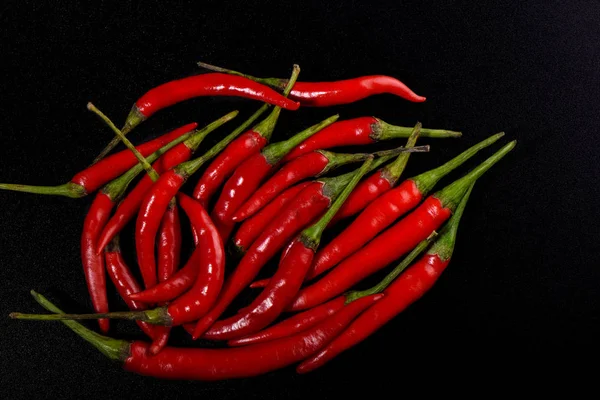 Pods of red hot pepper isolated on black color background. — Stock Photo, Image
