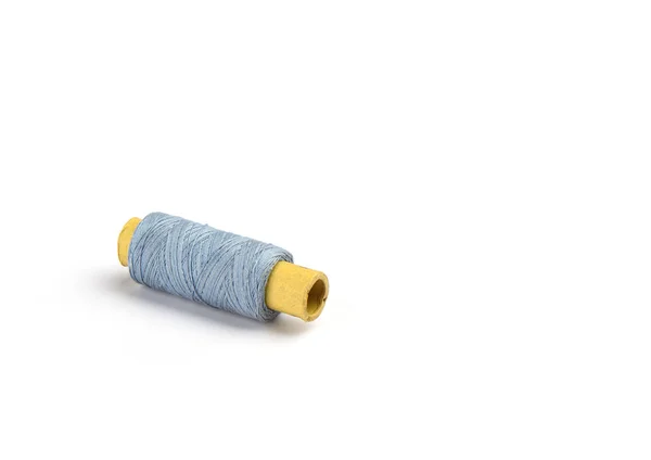 Hilos de algodón azul claro en la manga de cartón para la máquina de coser . — Foto de Stock