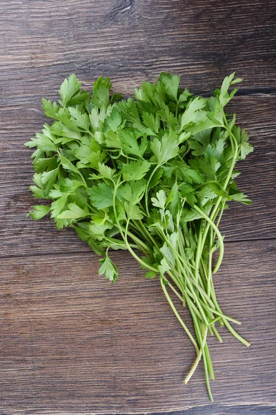 Fresh parsley on wooden table. Top view.