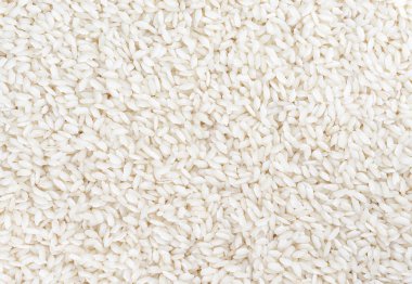 Arka plan olarak hazırlıksız beyaz pirinç. Üstte görüntü.