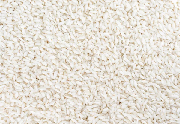 Arroz blanco sin preparar como fondo. Vista superior . — Foto de Stock