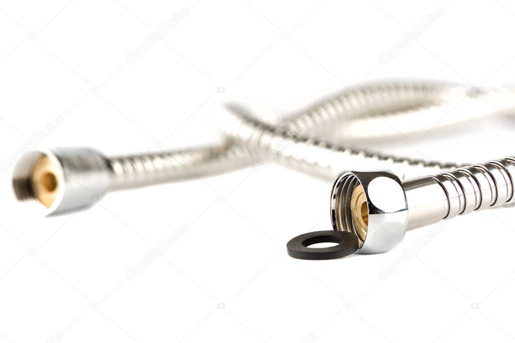 Selective focus. Shower hose for bathroom with rubber gasket on white background. Copy space. Close up.
