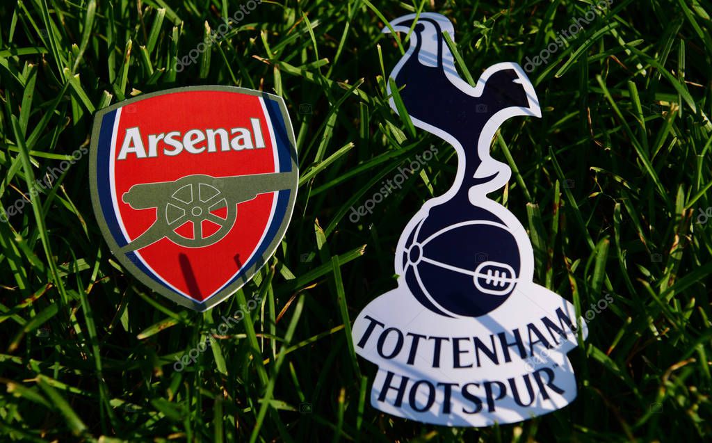 September 6, 2019 London, UK. Emblems of English football clubs rsenal F.C. London  and Tottenham Hotspur London on the green lawn grass.