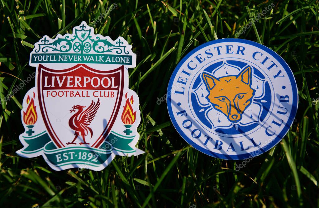 September 6, 2019 London, UK. Emblems of English football clubs Leicester City and Liverpool on the green lawn grass.