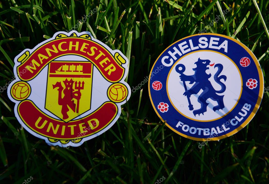 September 6, 2019 London, UK. Emblems of English football clubs Chelsea London and Manchester United on the green lawn grass.