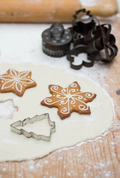Old iron cookie baker mold in a christmas baking interior with several pieces of decoration