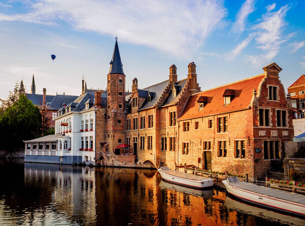 View at sunset of a Bruges' channel with hot air balloon