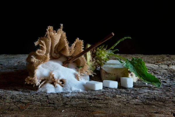 sugar beet and white sugar on an old wooden table