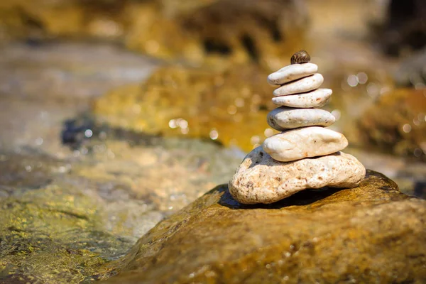 Balancing stones on the seashore