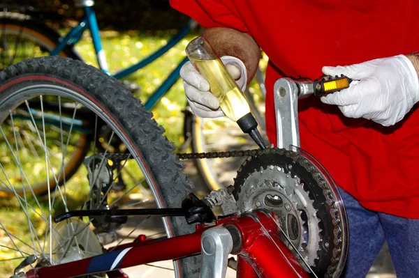 Bicycle maintenance and oiling by repairman. Bike mechanical service.