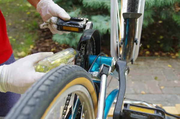 Bicycle maintenance and oiling by repairman. Bike mechanical service.