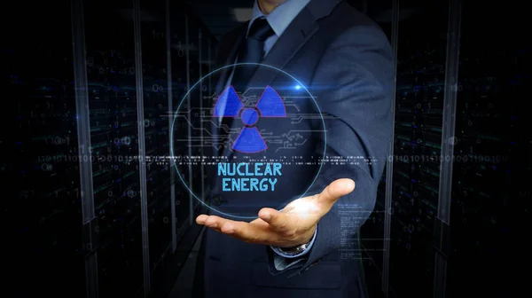 Touch screen uomo d'affari con ologramma simbolo di energia nucleare — Foto Stock